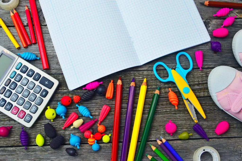 Notebook and calculator beside written calculations